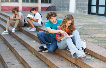 College students prepare together during recess outside