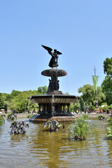 New York, USA - May 18 2023: Vertical View of a large fountain with a statue of an angel on top. The fountain is located in central park