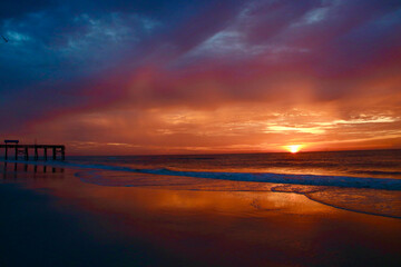 A beautiful combination of clouds and sun on a Florida beach during sunrise