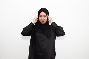 Sad woman in hijab holding hands on head, suffering from headache, suffering from migraine, feeling...