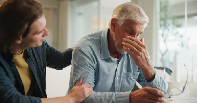 Sad, senior father and man on sofa for depression, comfort or support in living room. Family, mourning and elderly parent crying with grief for bad news, mental health or memory of wife in home