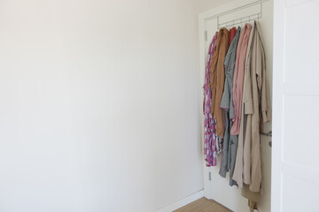 shirts hung on clothes hangers as a decorative fixture on the door ,