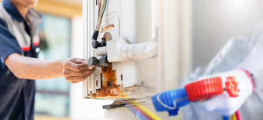 Technician service for repair and maintenance of air conditioners, Repairman fixes air conditioning systems.