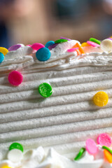 Side of a Birthday Cake with rainbow sprinkles 