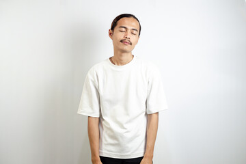 Young man wearing a white t-shirt. with a lazy and sleepy expression. isolated in white background