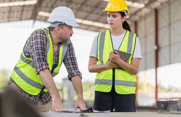 Site manager and builder inspect the construction site, Female foreman worker and engineer team meeting for planning project at the precast concrete factory site