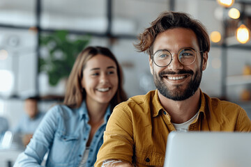 Smiling businessman and businesswoman working together during team presentation in office meeting room