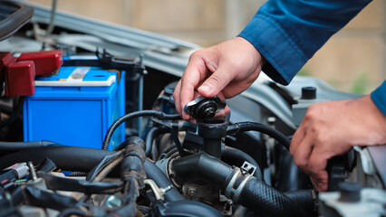 Car care and service A technician is troubleshooting an engine. Spare parts of car engines that have problems and support car insurance services, standard car repair service center concepts.