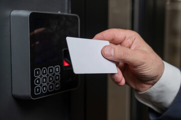 A man opens the door with a card. Modern electronic lock. Keyless Entry