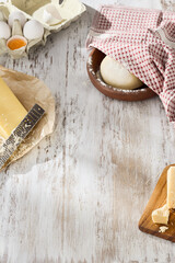 Family Baking Together at Home: Mother, Father, and Child Making Pizza Dough in a Sunny Kitchen