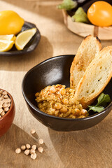 Diverse Group Enjoying Hummus with Crispy Toasts at a Cozy Home Gathering, Casual Wear, Cheerful Atmosphere