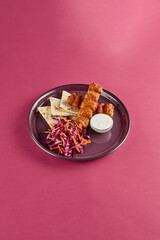 Chicken Lyulya Kebab with Coleslaw Salad and Pita Bread on a Stylish Pink Background