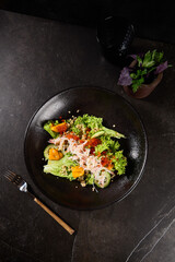 Quinoa Salad with Crab and Mango Mousse on Dark Ceramic Plate - Gourmet Seafood Dish