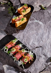 Aesthetic Setup of Asian Snacks on Stone Background Culinary Richness Captured in Two Plates