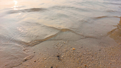 Close up soft wave lapped the sandy beach. natural abstract background and texture © Tito Rollis