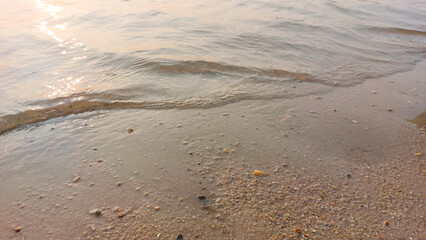 Close up soft wave lapped the sandy beach. natural abstract background and texture