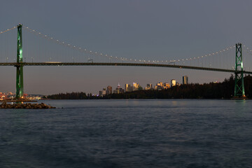 Vancouver Skyline and Lions Gate Bridge at dusk as seen from Ambleside Park in West Vancouver