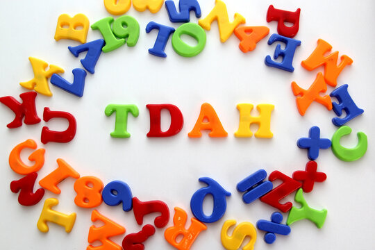 Colored toy letters for children form the word TDAH which means Attention Deficit Hyperactivity Disorder in Spanish that occurs with inattention, hyperactivity and impulsivity