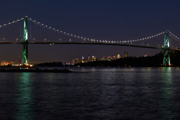 Obraz premium Vancouver Skyline and Lions Gate Bridge at dusk as seen from Ambleside Park in West Vancouver