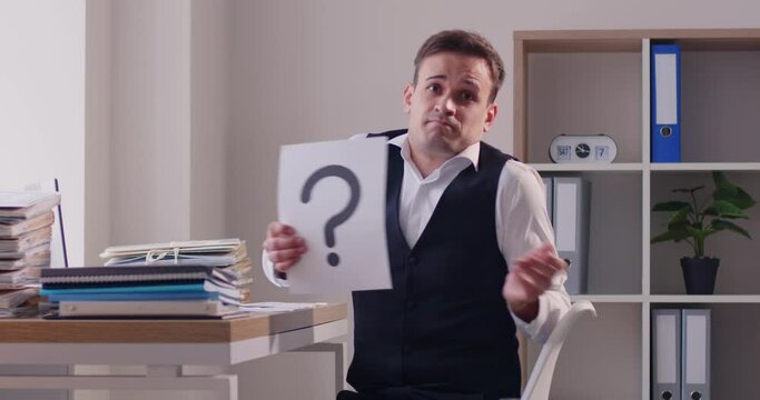 Questioning businessman, doubtful office worker showing question mark, asking for help. Confused or puzzled man having difficult task or problem requiring resolution, embarrassing situation at work