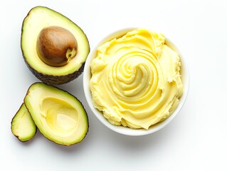 Fresh avocado halves and creamy avocado butter in a bowl on white background, showcasing healthy and delicious food ingredients.
