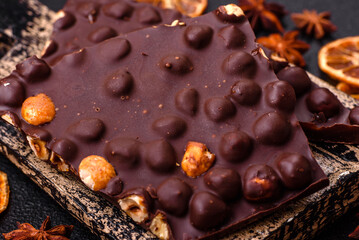 Black bitter chocolate with whole hazelnuts, candied fruits and mint