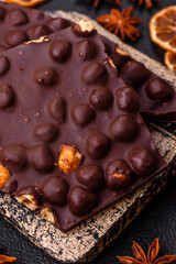 Black bitter chocolate with whole hazelnuts, candied fruits and mint