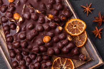 Black bitter chocolate with whole hazelnuts, candied fruits and mint