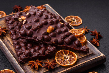 Black bitter chocolate with whole hazelnuts, candied fruits and mint