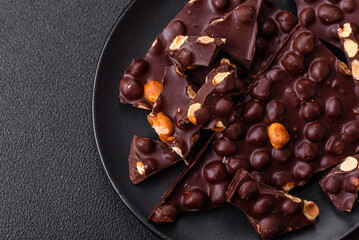 Black bitter chocolate with whole hazelnuts, candied fruits and mint