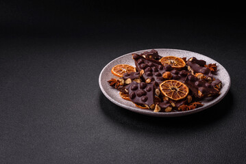 Black bitter chocolate with whole hazelnuts, candied fruits and mint