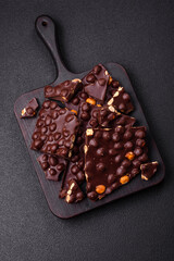 Black bitter chocolate with whole hazelnuts, candied fruits and mint