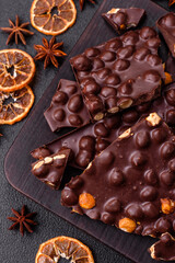 Black bitter chocolate with whole hazelnuts, candied fruits and mint