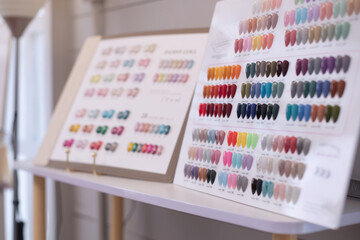 Colorful chart of nail polish colors is displayed in beauty shop, nail polish swatches in different fashion color