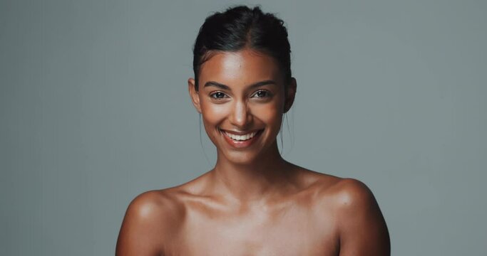 Portrait, skincare and beauty of happy Indian woman in studio isolated on gray background. Face, smile and young model in makeup for facial cosmetics, dermatology or healthy glow for aesthetic at spa