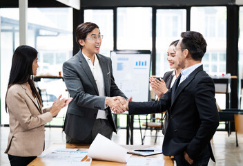 Asian business people and handshake for welcome, introduction or greeting in office. Shaking hands, smile and team with deal for collaboration, agreement