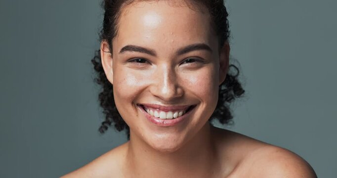 Woman, face and skincare or happy in studio, smile and acne treatment for dermatology wellness. Glowing, clean and routine transformation, background and confident for natural breakout prevention
