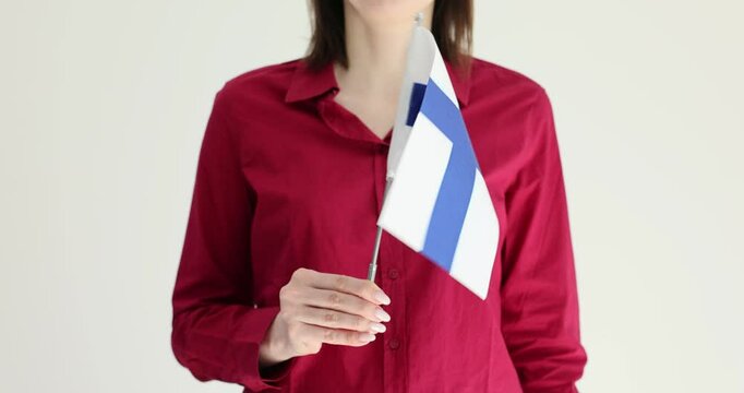 Worker celebrates Finland tradition with flag in hand