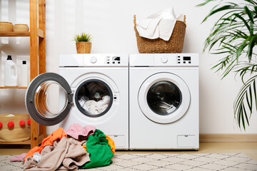Laundry Day in a Modern Home With White Washers and a Wooden Shelf © fotofabrika