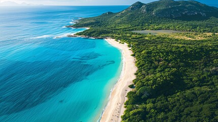 An overhead view of a pristine coastline with turquoise waters, white sandy beaches, and lush green vegetation