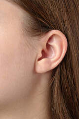 Close-Up View of a Human Ear and Brown Hair