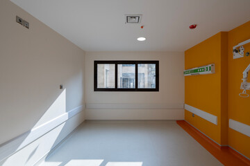 Vibrant empty hospital rooms with modern orange and grey flooring, radiating a calming yet professional atmosphere
