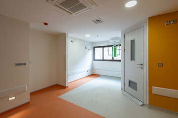 Vibrant empty hospital rooms with modern orange and grey flooring, radiating a calming yet professional atmosphere