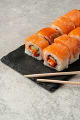 Close up of sushi rolls on gray table