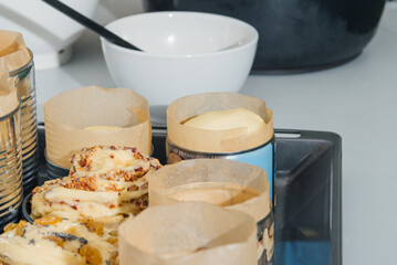 Baking Easter cakes in molds from empty tin cans. On a tray before going into the oven