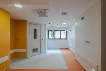 Vibrant empty hospital rooms with modern orange and grey flooring, radiating a calming yet professional atmosphere