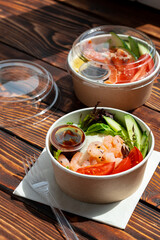 Take out poke bowl on wooden background