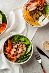 Beautiful composition with poke bowls on gray background with napkin