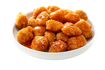 Closeup of golden and crispy Honey BBQ chicken nuggets isolated on a white transparent background.