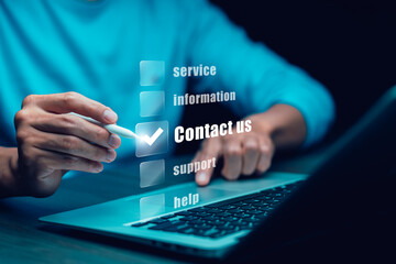 Communication and Contact us or Customer support hotline people connect. Hand using a laptop and touching on virtual screen contact icons, email and address, live chat with internet wifi.